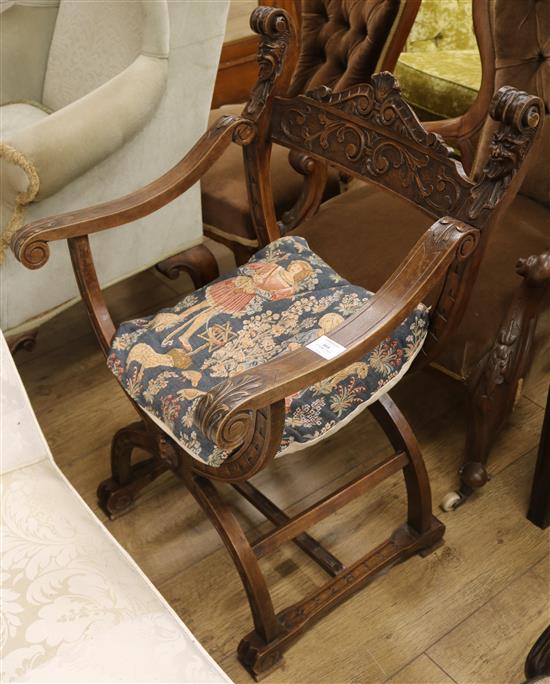A carved walnut X frame chair